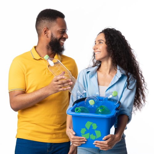 Waste Sorting. Multicultural Family Couple Sorting Junk Posing Holding Box With Recycle Symbol Full Of Used Plastic Bottles Standing Over White Background. Studio Shot. Trash Disposal Concept